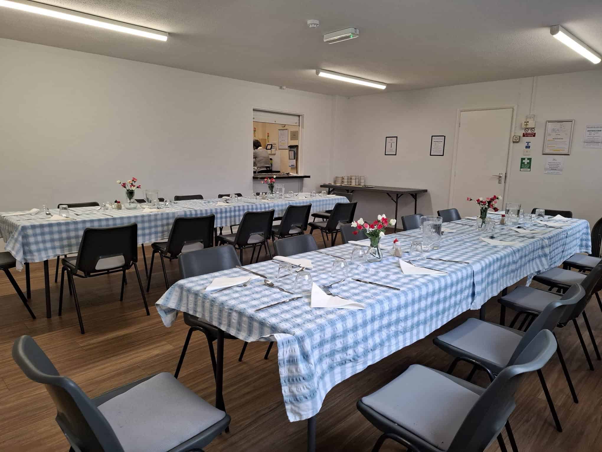 Event hall with decorated tables for meetings and celebrations.